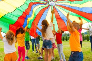 Build Bilateral Coordination with a Parachute Group of Children Playing with a Parachute