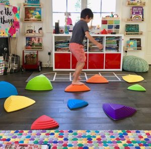 Challenge Balancing Skills with Stepping Stones Child in play room balancing on stepping stone