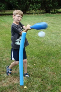 How to Make A Batting Tee from Pool Noodles Hit A boy hitting a wiffle ball from a pool noodle tee