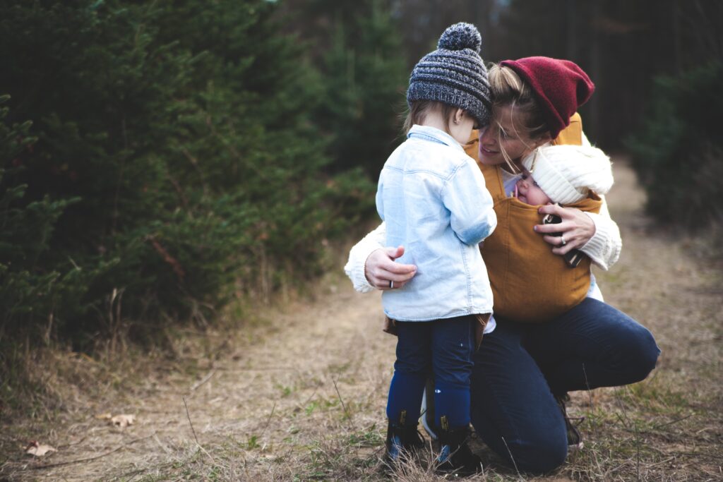 Parent hugging a child outdoors