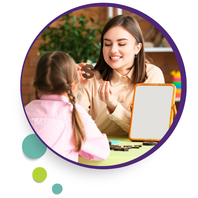 Therapist working with a young girl at a table