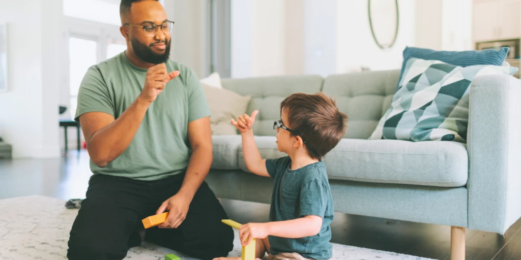 deaf child practicing sign language with speech therapist