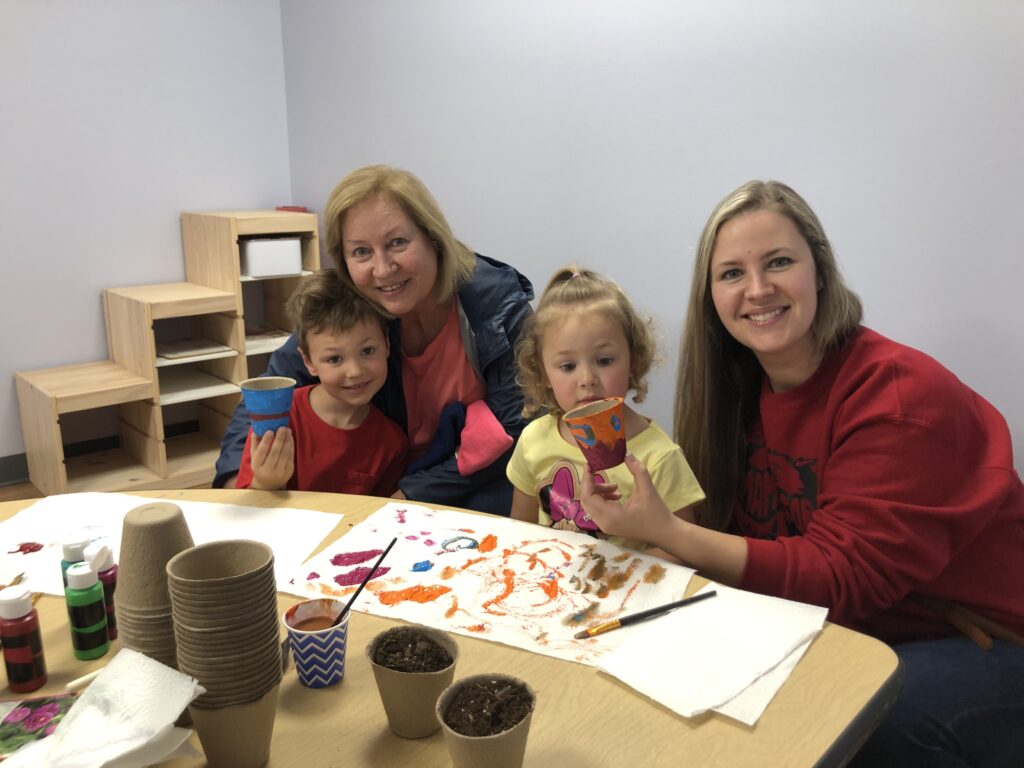 Therapists and children at a craft table at the North Mayfair clinic