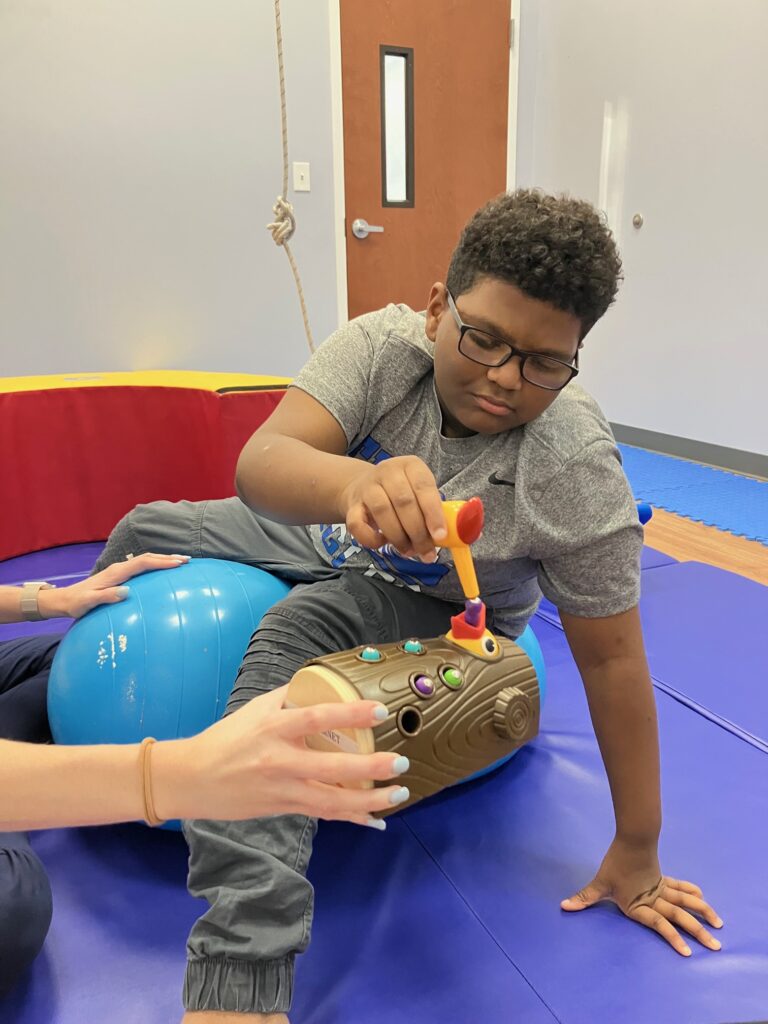 Child playing with a toy during a therapy session