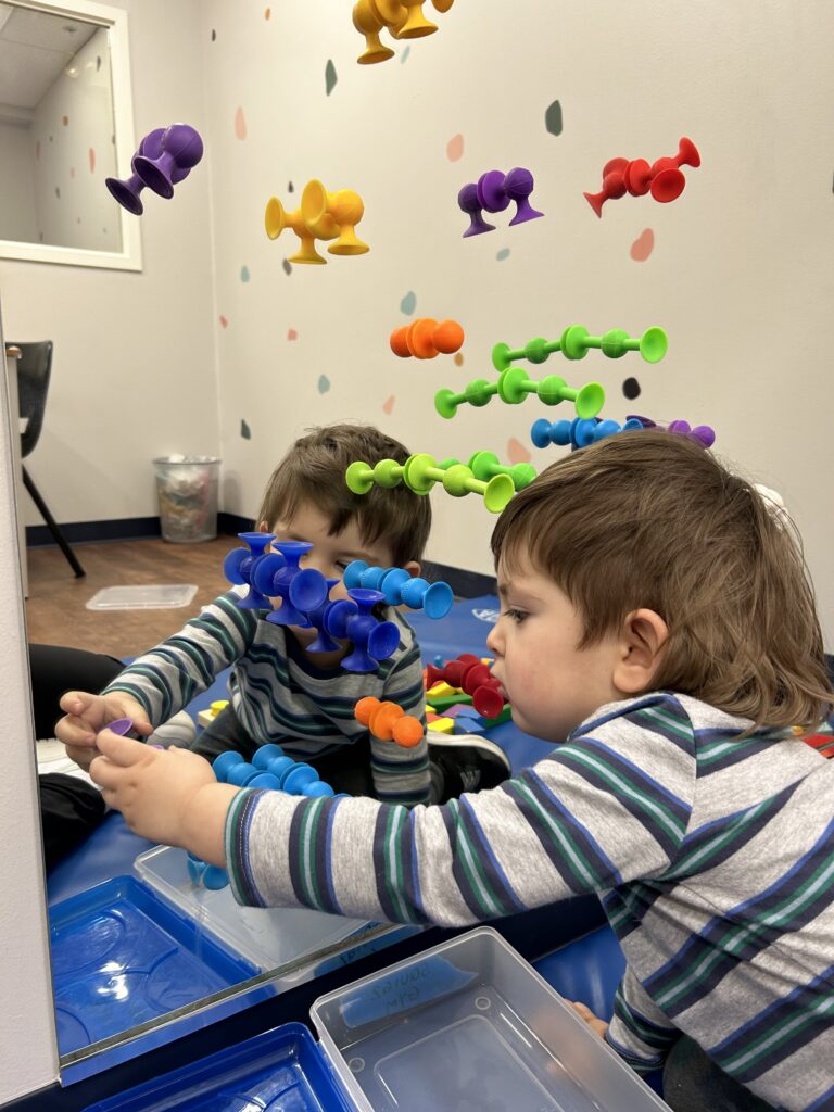 Child playing with a toy at a table