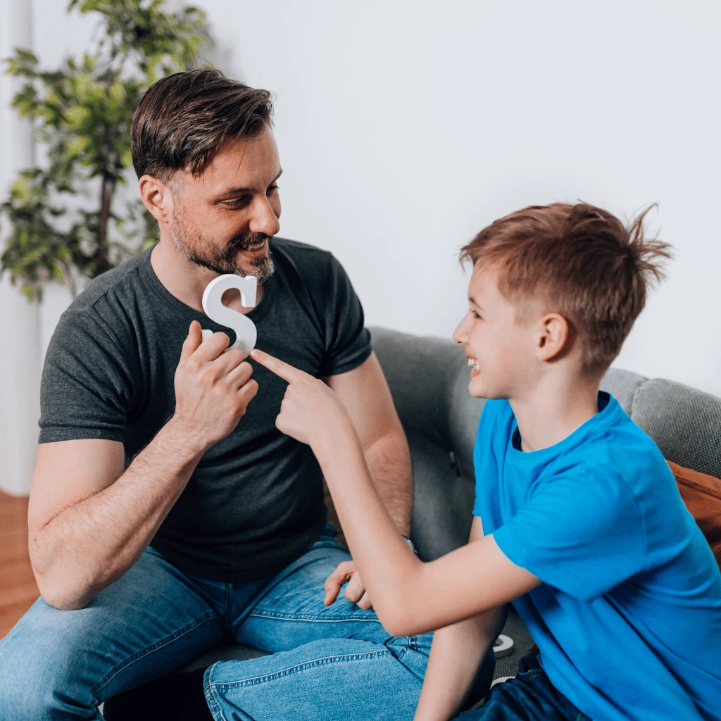 Father and son practicing the letter S